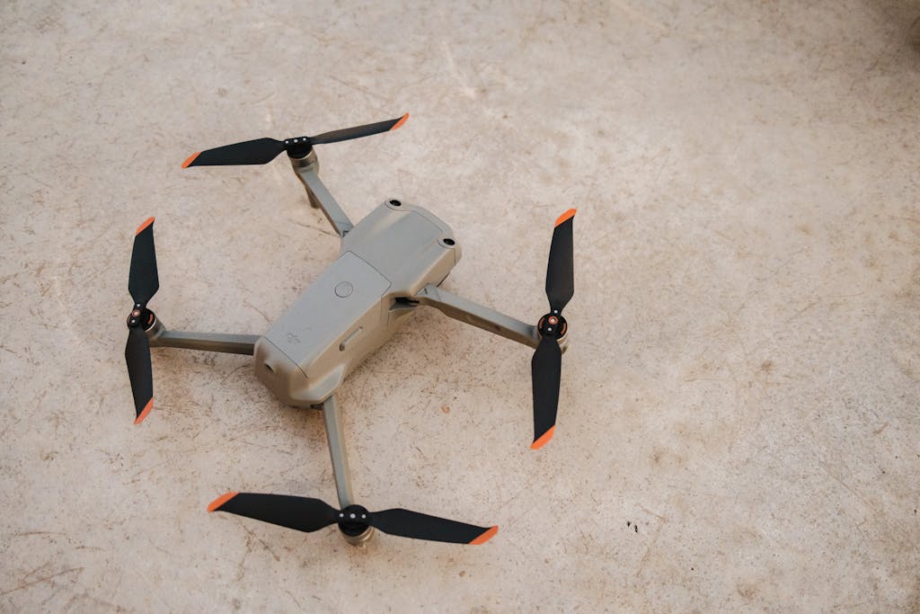 A small drone with propellers on the ground